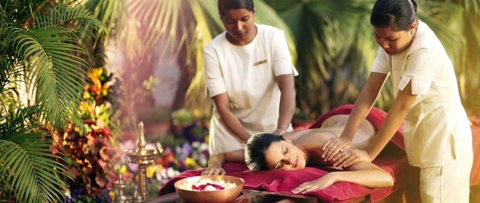Four-handed abhyanga in a garden: two therapists giving an oil massage