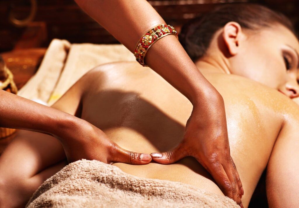 A therapist's hands during an oil massage