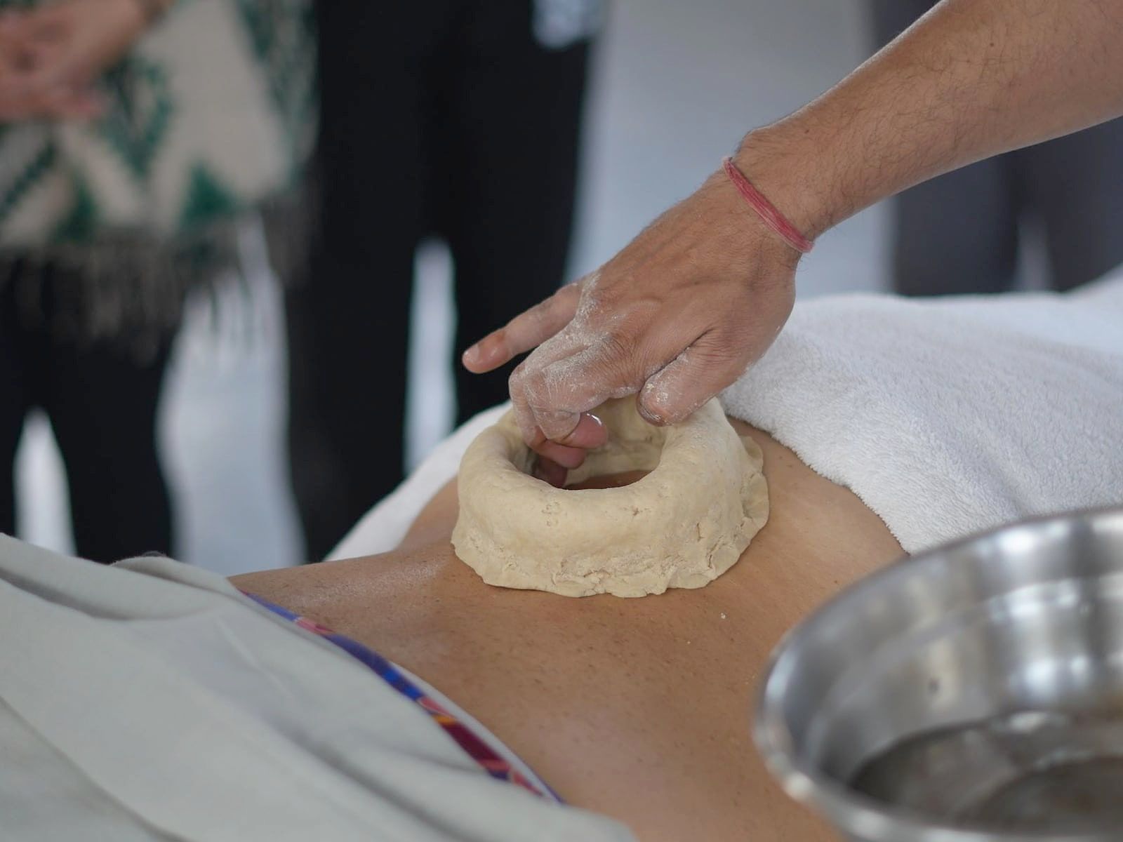 Kati basti: a ring of dough on the lower back holding warm oil