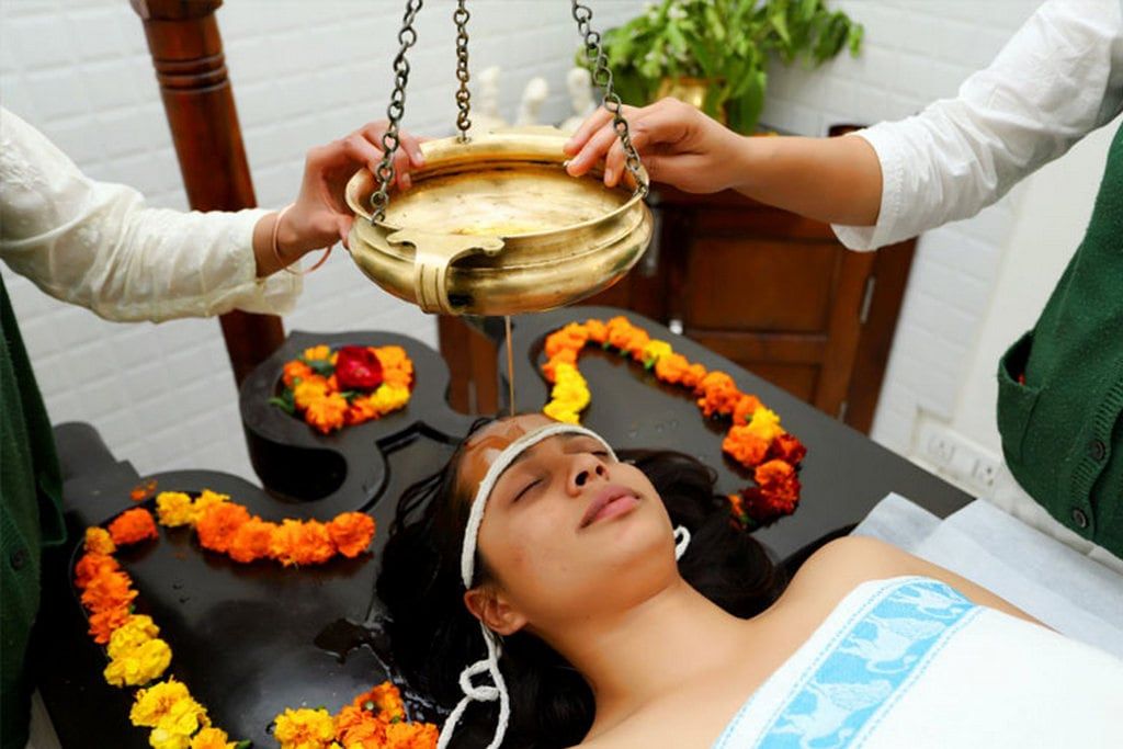 Shirodhara: warm oil pouring onto the forehead