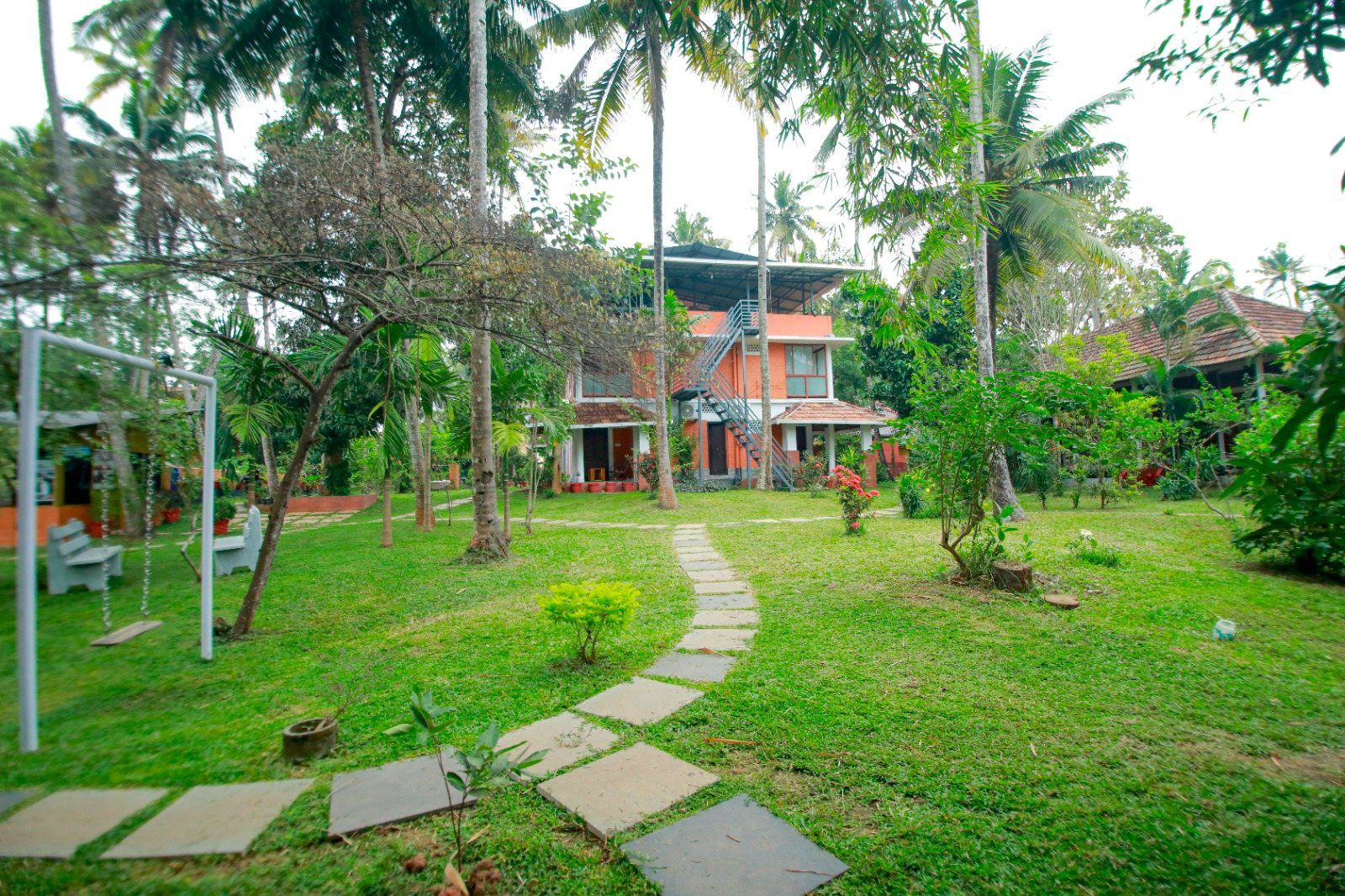 A stone path through the center's garden to a building with terraces