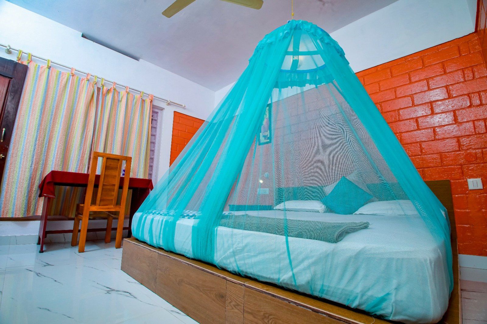 A room for panchakarma guests in Varkala: bed with a mosquito net